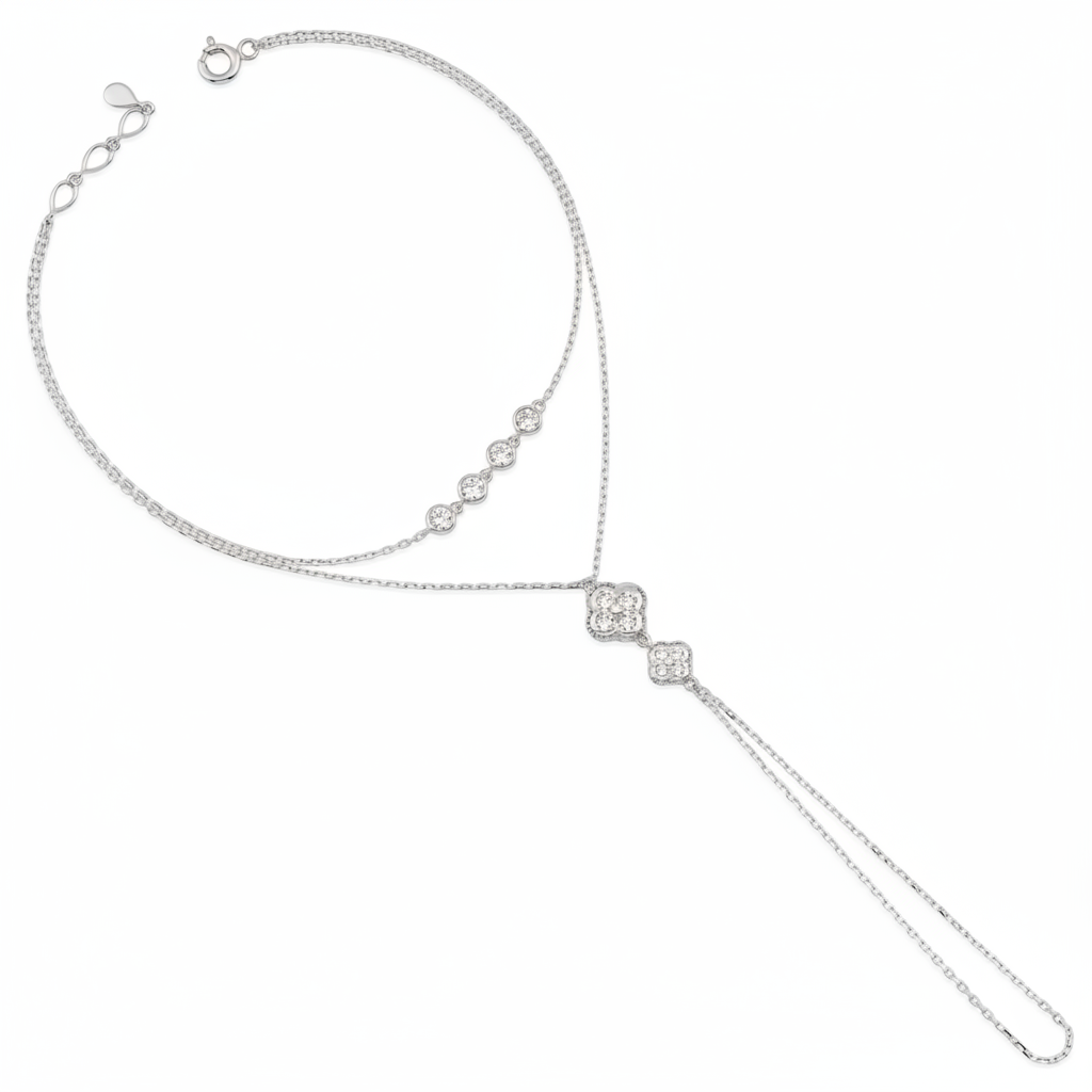 white gold hand chain bracelet with bezel-set stones and a floral motif drop on white background