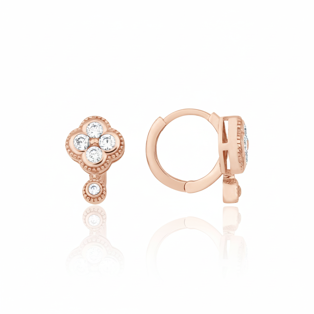 rose gold clover huggie hoop earrings with White CZ stones on white background
