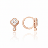 rose gold clover huggie hoop earrings with White CZ stones on white background