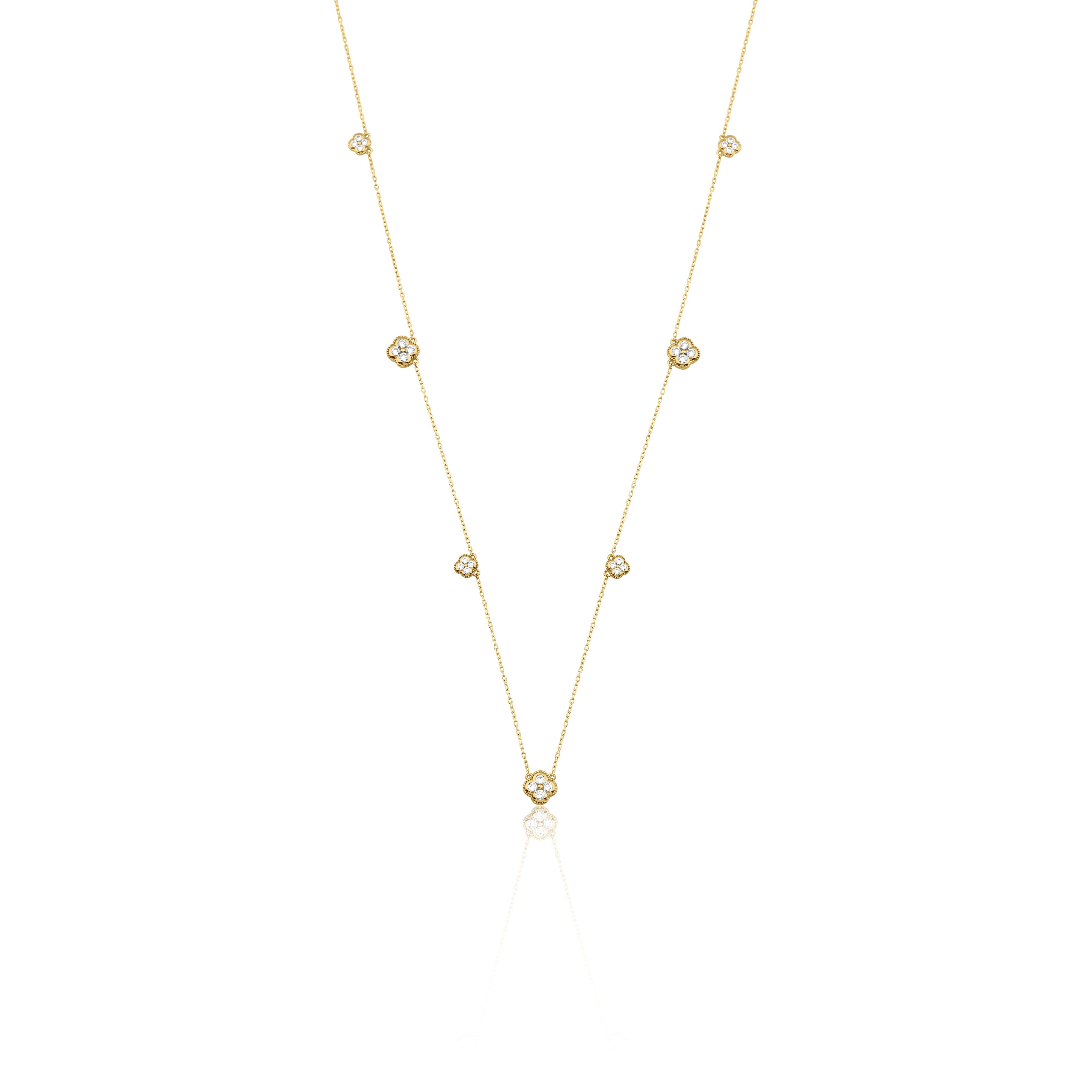 Yellow gold clover station necklace with White CZ stones on white background
