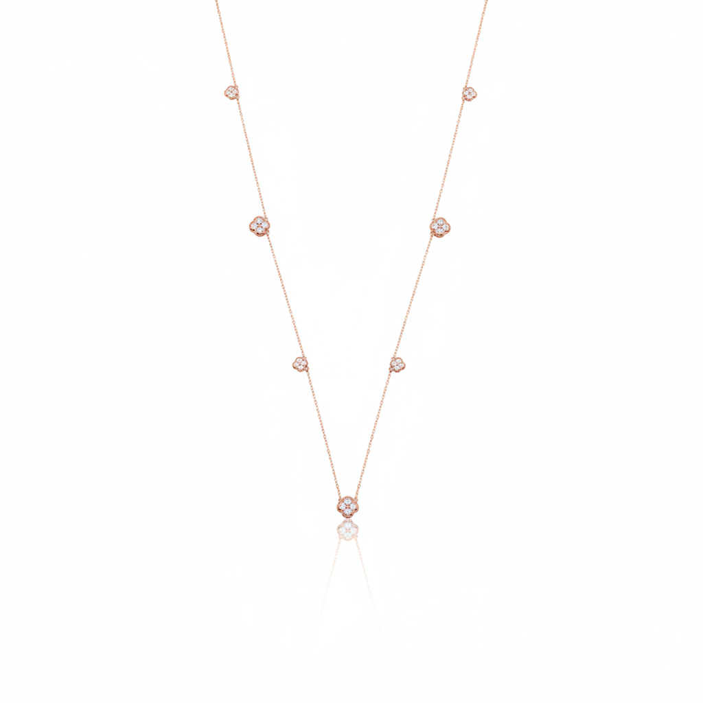 Rose gold clover station necklace with White CZ stones on white background