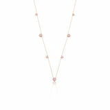 Rose gold clover station necklace with White CZ stones on white background
