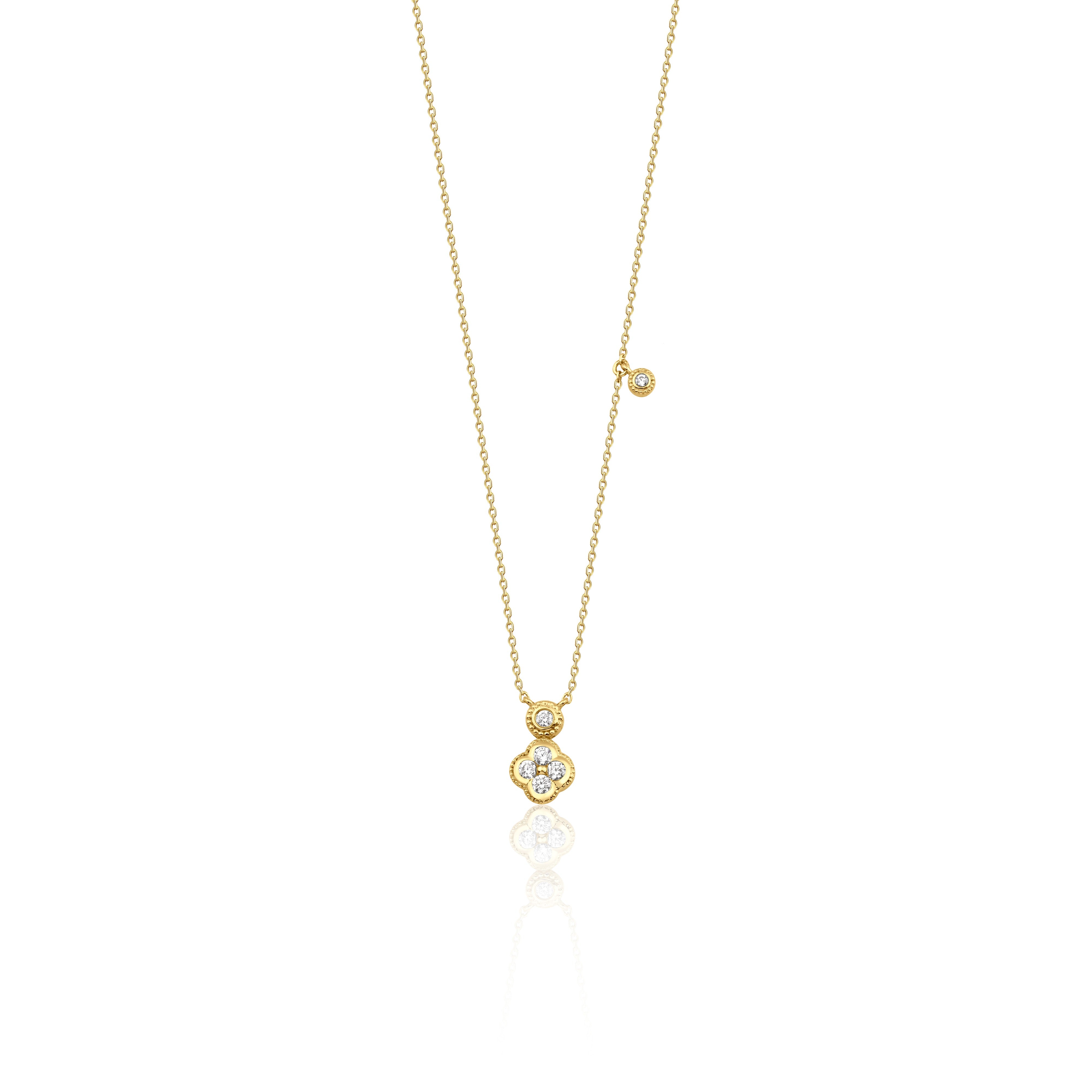 Yellow gold clover charm necklace with a bezel-set accent stone on white background