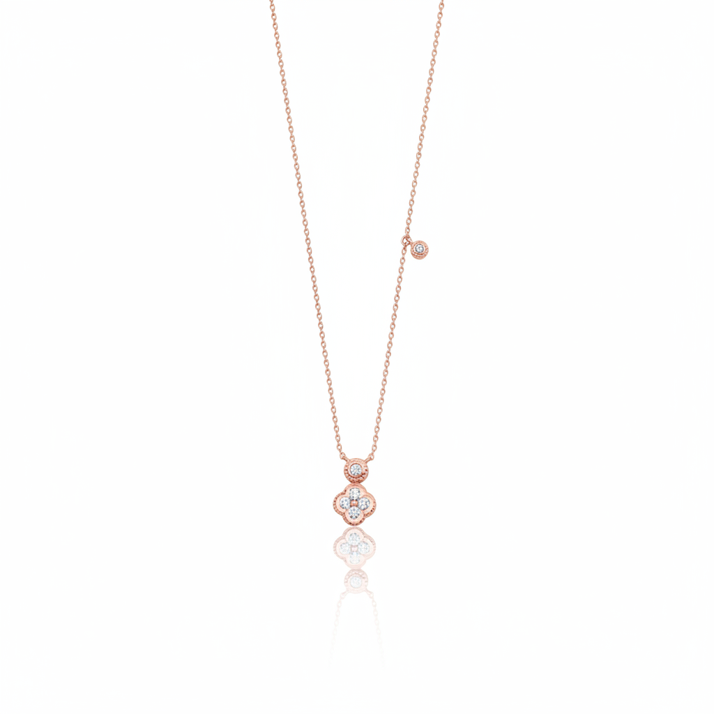Rose gold clover charm necklace with a bezel-set accent stone on white background