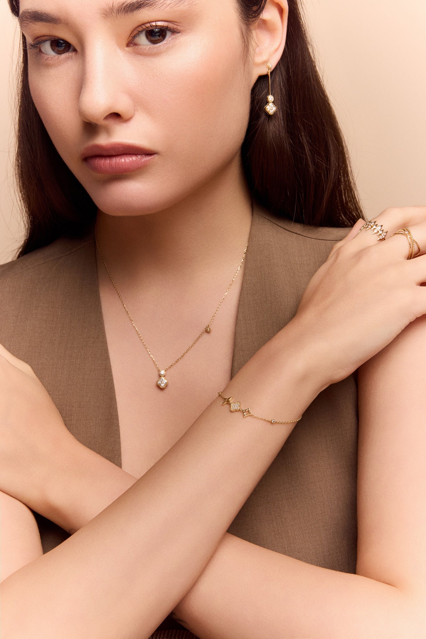 model wearing the gold clover charm necklace