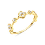 Yellow gold clover band ring with White CZ stones on white background