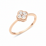rose gold four-leaf clover ring with White CZ stones on white background