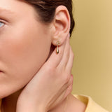 model wearing the gold petal drop earrings