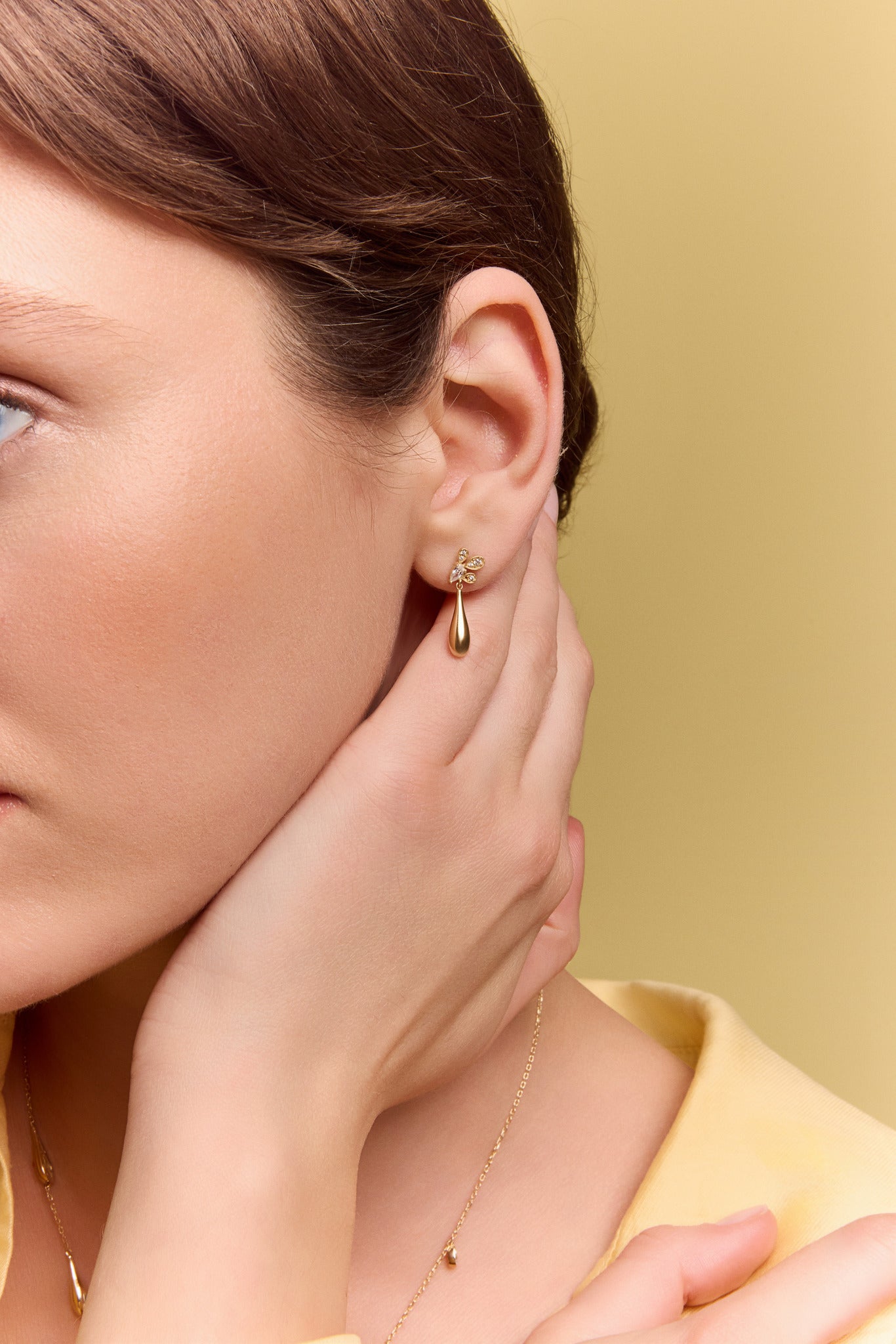 model wearing the gold petal drop earrings