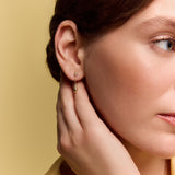 model wearing the gold chain teardrop earrings