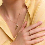 model wearing the gold crossed drops pendant necklace