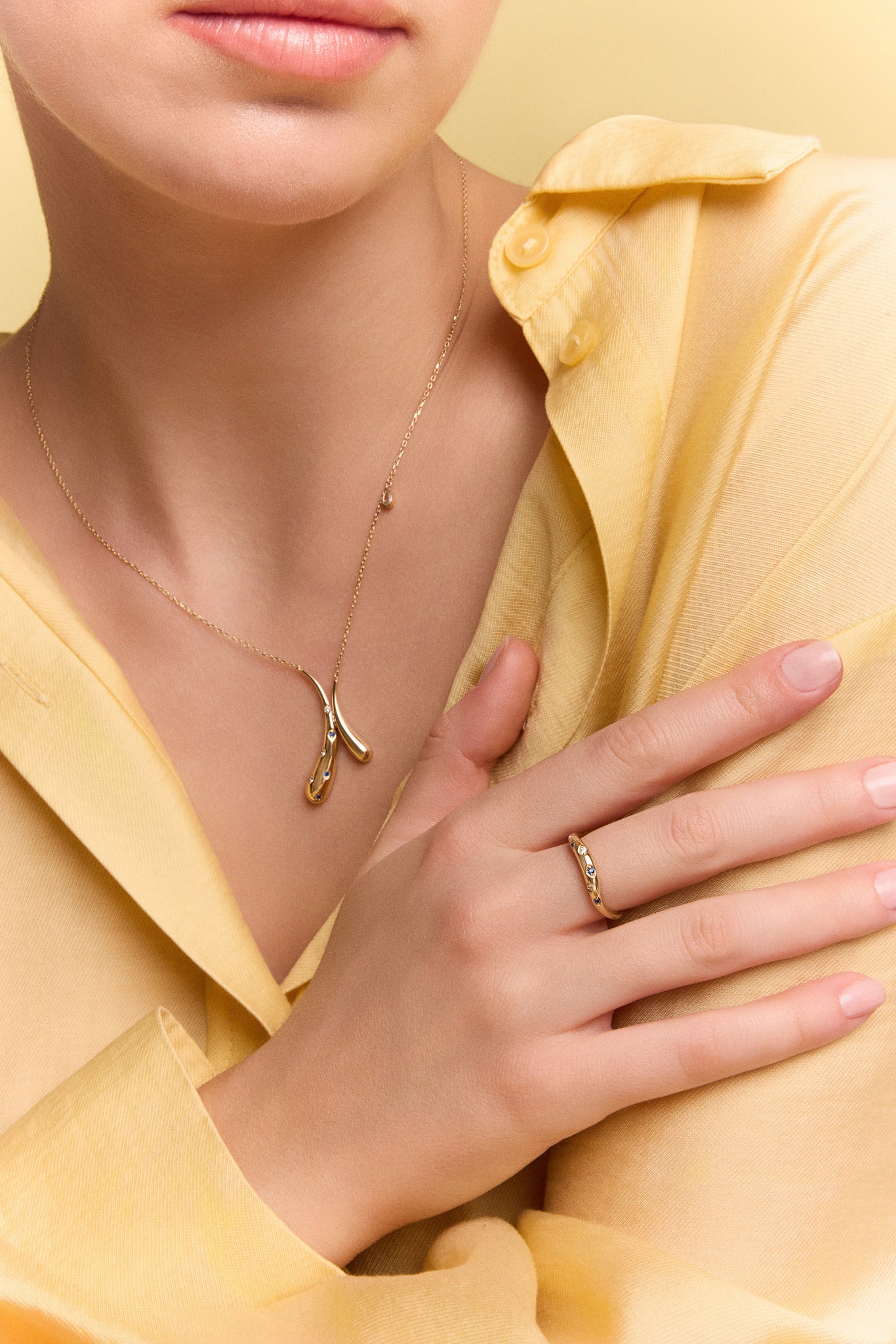 model wearing the gold crossed drops pendant necklace