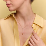 model wearing the gold lariat drop necklace