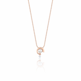 rose gold crescent pendant necklace with a pearl on white background