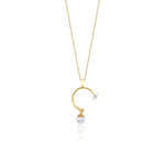 yellow gold open arc pendant necklace with a dangling pearl on white background