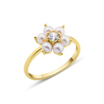 yellow gold floral band ring with pearls on white background