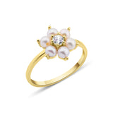 yellow gold floral band ring with pearls on white background