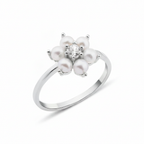 white gold floral band ring with pearls on white background