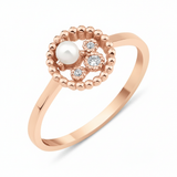 rose gold asymmetrical halo ring with a pearl on white background