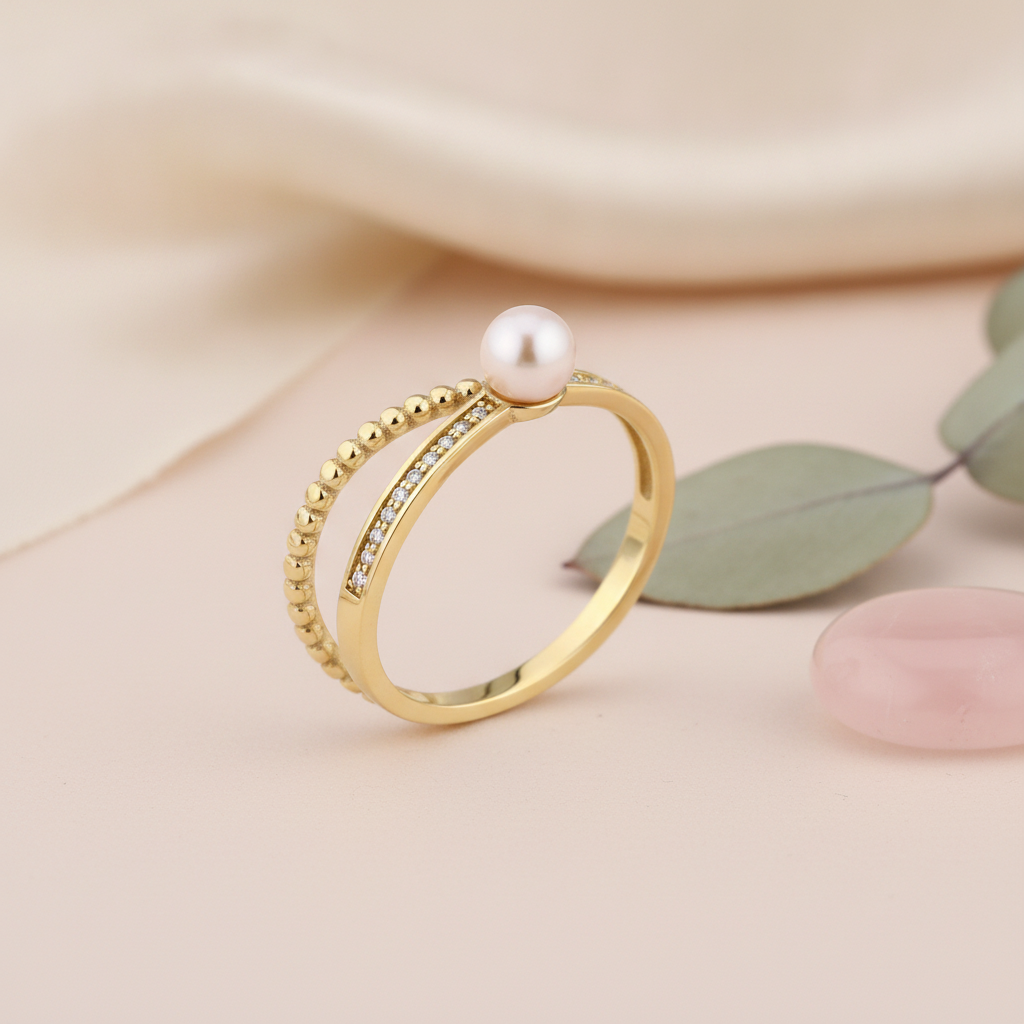 yellow gold twisted rope double-band ring with a pearl and clear stones, styled on cream silk with dried baby's breath