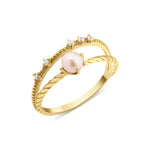 yellow gold solitaire pearl ring on white background