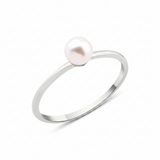 white gold criss-cross ring with a pearl and a marquise stone on white background