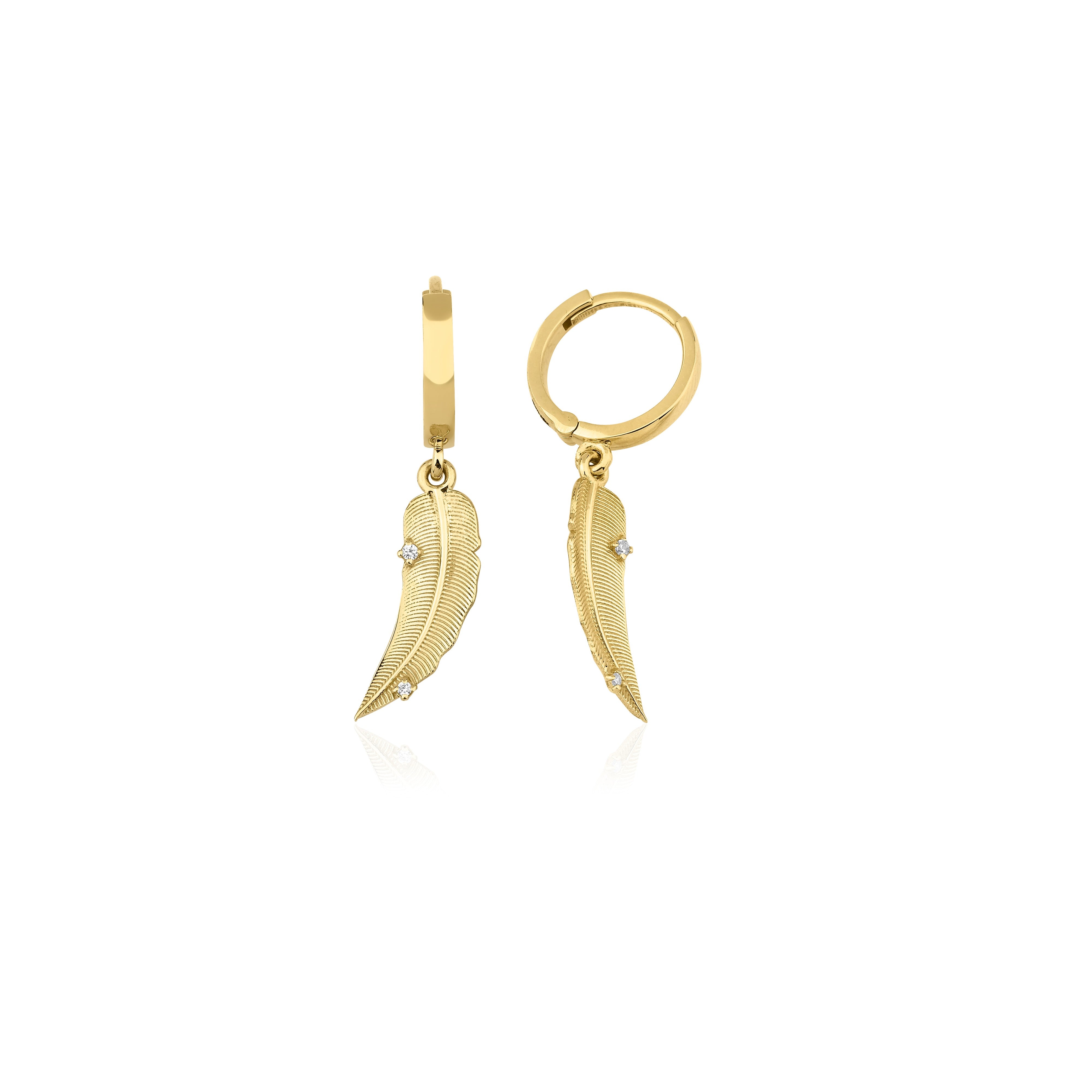 yellow gold feather huggie earrings on white background