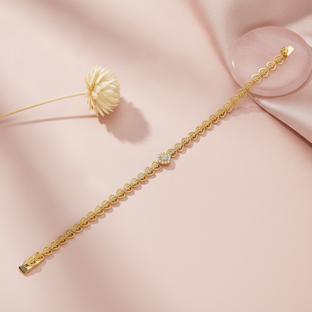 lace-like filigree gold bracelet with a pave-set medallion, shown on pink fabric with a dried flower and a rose quartz dish
