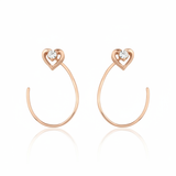 open heart hoop earrings in rose gold on white background