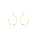 open loop earrings in yellow gold on white background