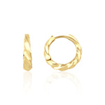 yellow gold twist huggie earrings on white background