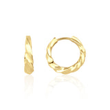 yellow gold twist huggie earrings on white background