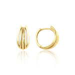 yellow gold arc huggie earrings on white background