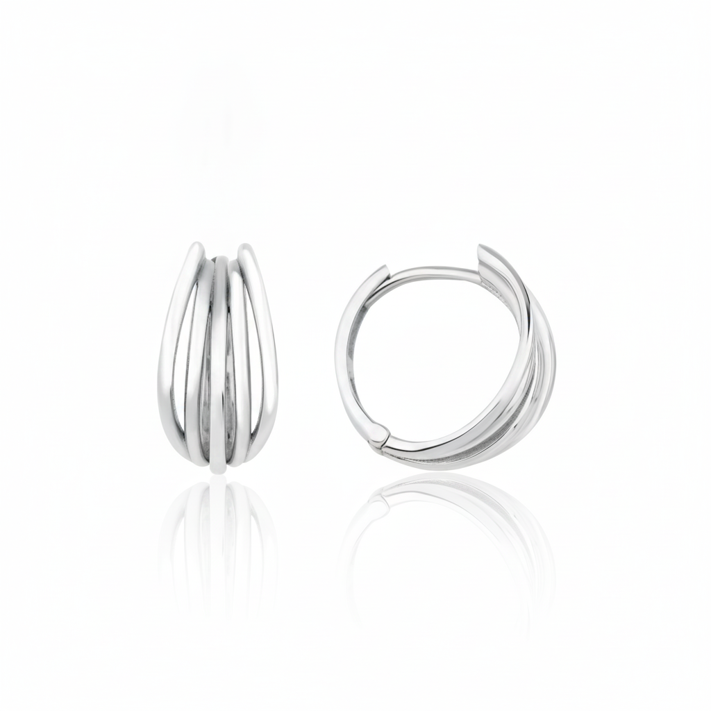 white gold arc huggie earrings on white background