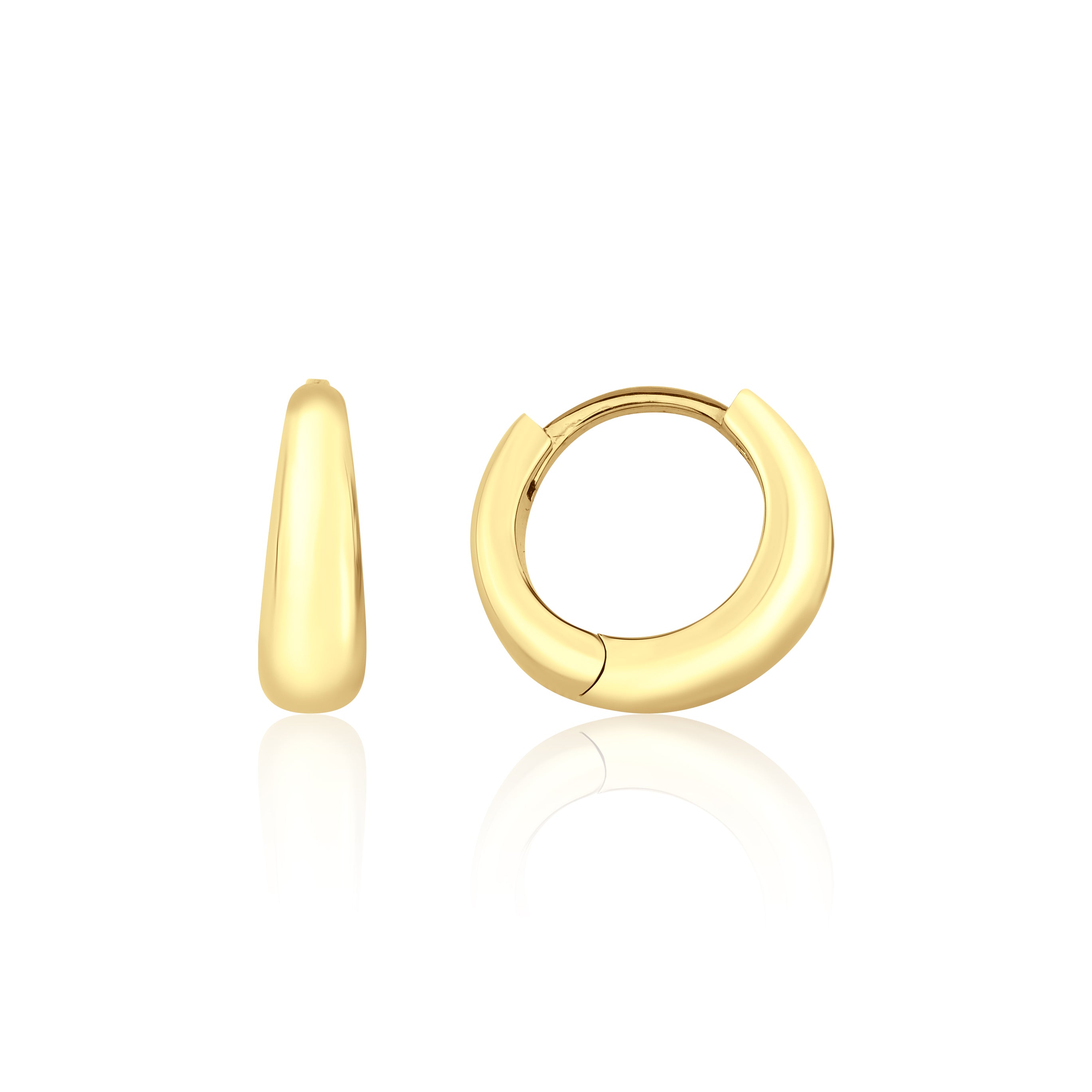 yellow gold volume huggie earrings on white background