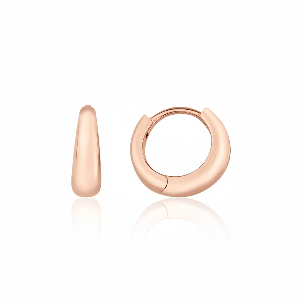 rose gold volume huggie earrings on white background