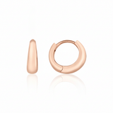 rose gold volume huggie earrings on white background
