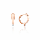 rose gold tapered spark huggie earrings on white background