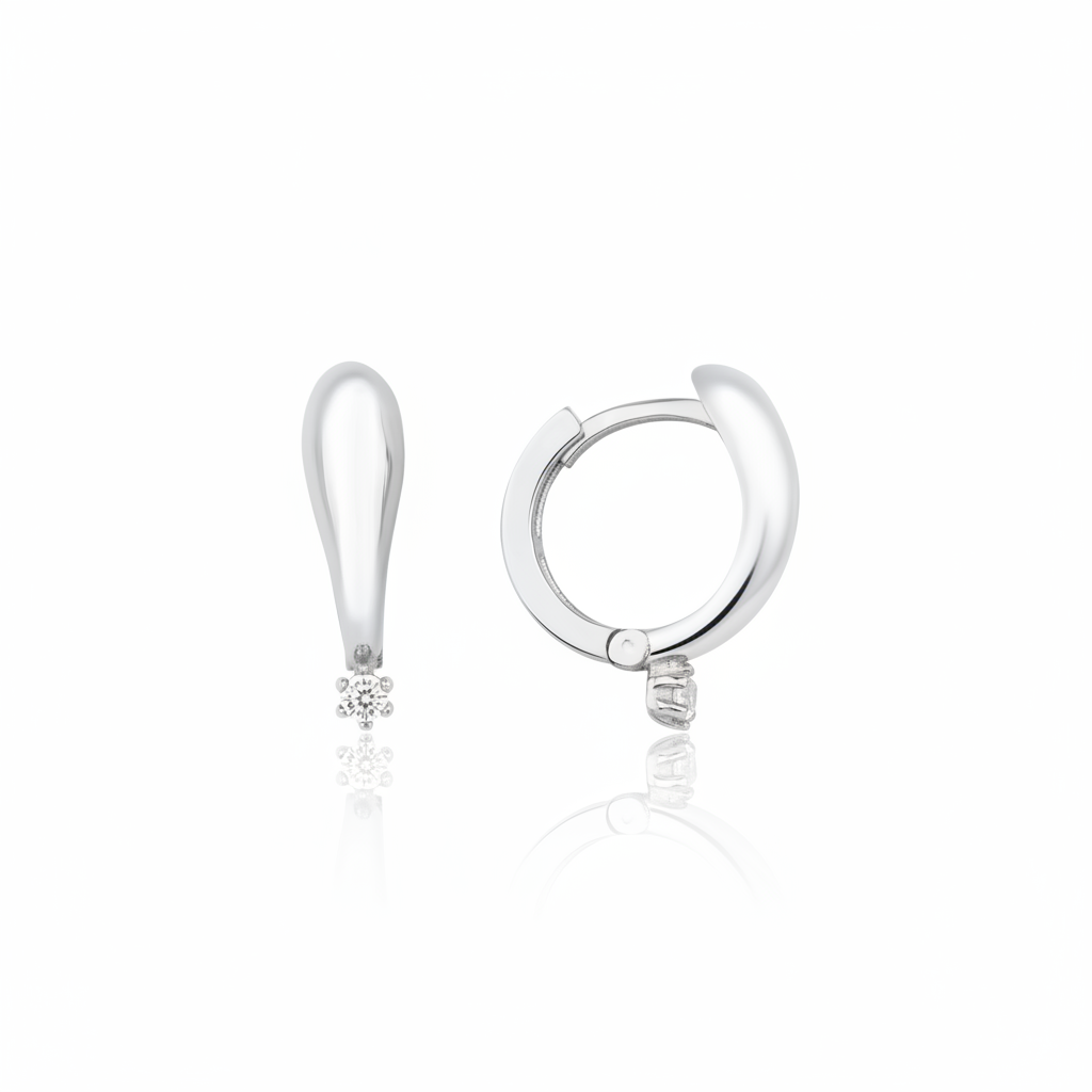 white gold tapered spark huggie earrings on white background