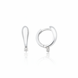 white gold tapered spark huggie earrings on white background