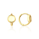 yellow gold disk huggie earrings on white background