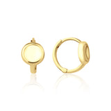 yellow gold disk huggie earrings on white background