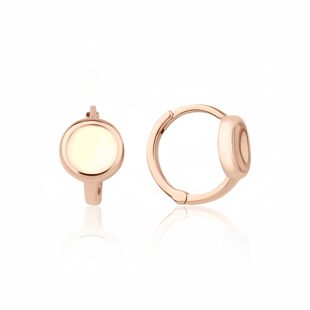 rose gold disk huggie earrings on white background