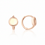 rose gold disk huggie earrings on white background