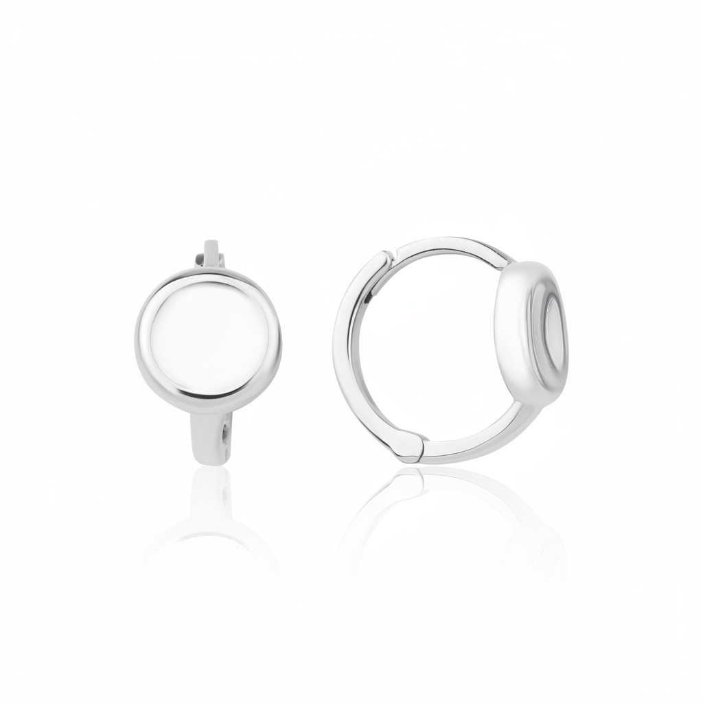 white gold disk huggie earrings on white background