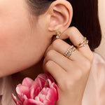 model wearing the gold circle drop huggie earrings