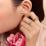 model wearing the gold circle drop huggie earrings