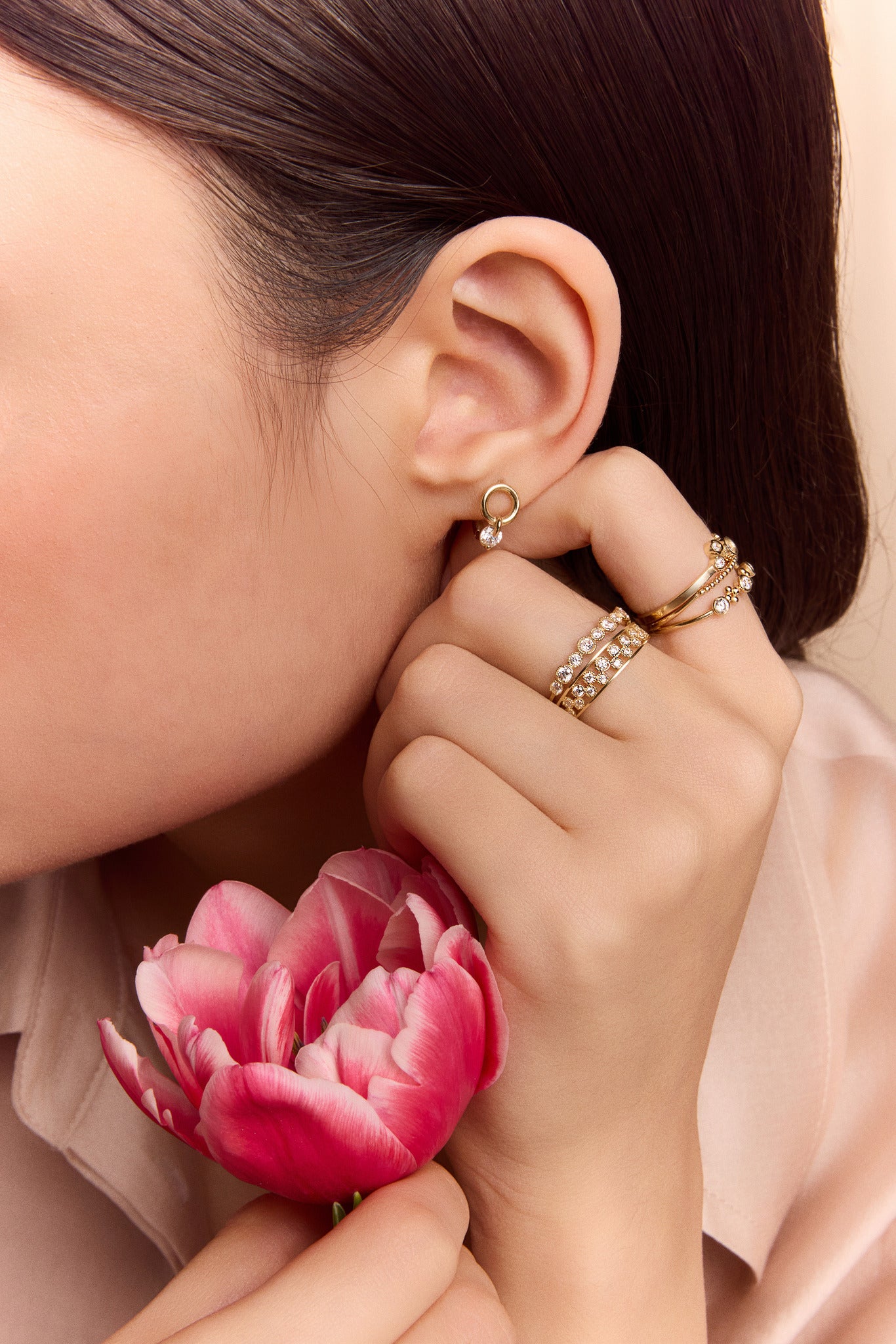 model wearing the gold circle drop huggie earrings