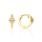 yellow gold star huggie earrings on white background