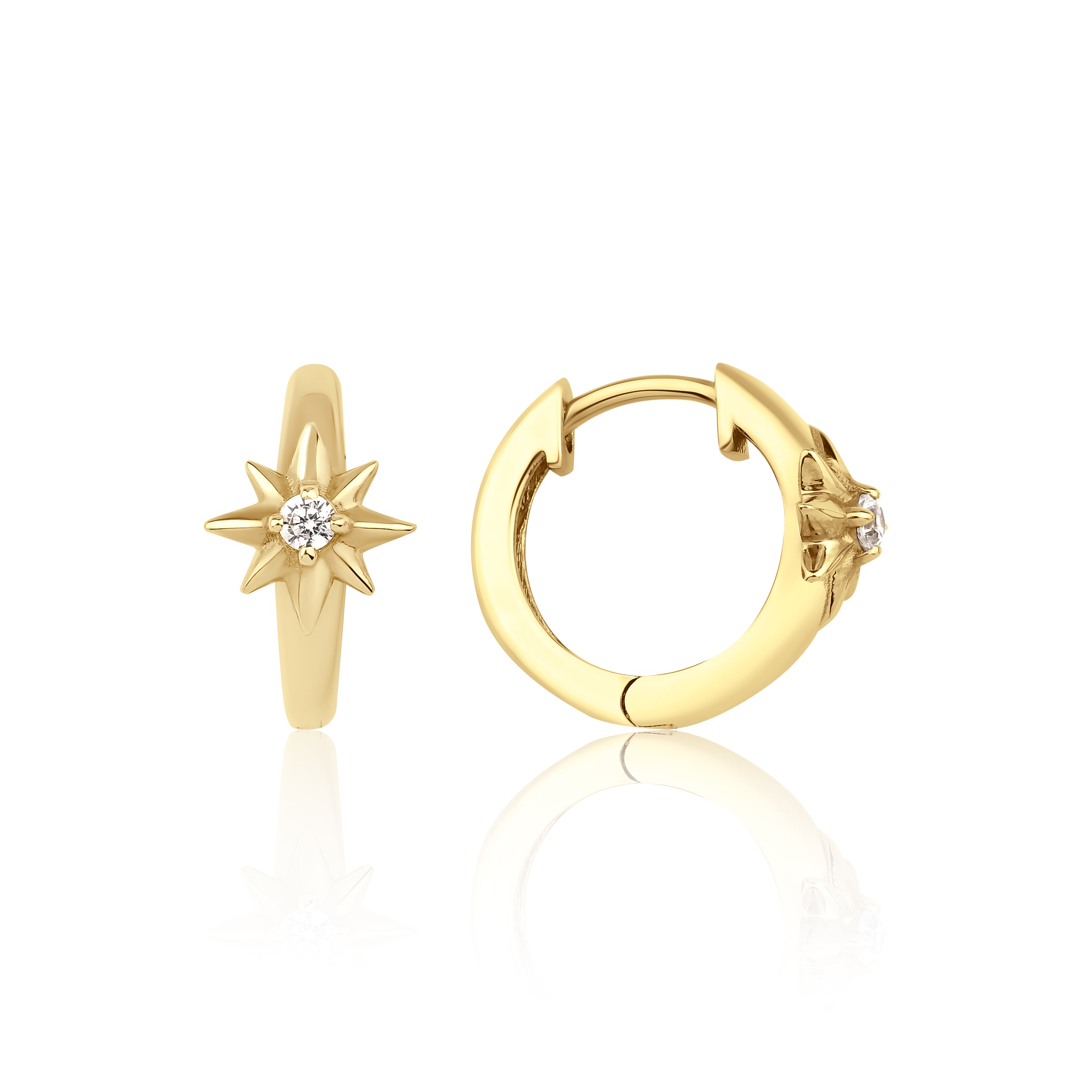 yellow gold star huggie earrings on white background